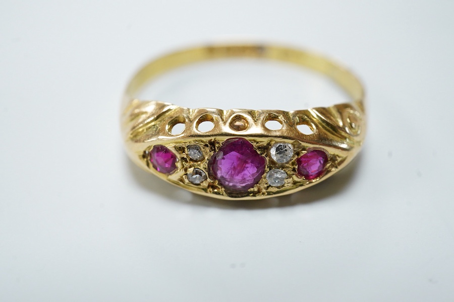 A ruby and diamond ring, circa 1916, set with three circular-cut rubies, spaced by pairs of circular-cut diamonds, mounted in 18ct gold, size R1/2, British hallmarks, gross weight approximately 2 grams, one ruby syntheti